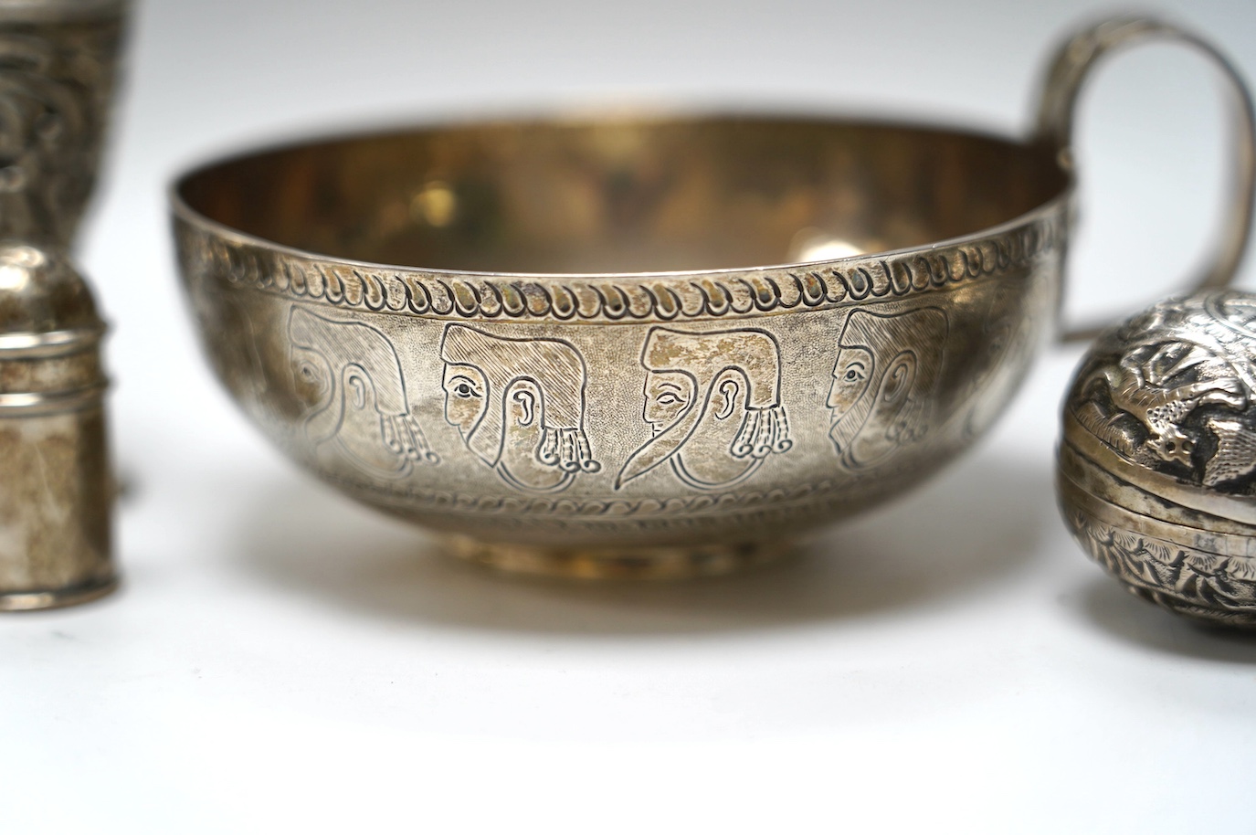 An Edwardian silver replica of a Mycenaean cup, Nathan & Hayes, Chester, 1912, height 62mm, together with a late Victorian silver mounted scent flask, two silver condiments and an Indian white metal box and cover. Condit